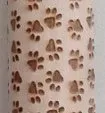 Wooden rolling pin with embossed Christmas patterns, 45cm long, on a kitchen worktop.
