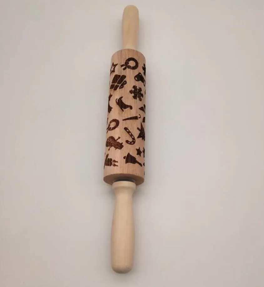Wooden rolling pin with embossed Christmas patterns, 45cm long, on a kitchen worktop.