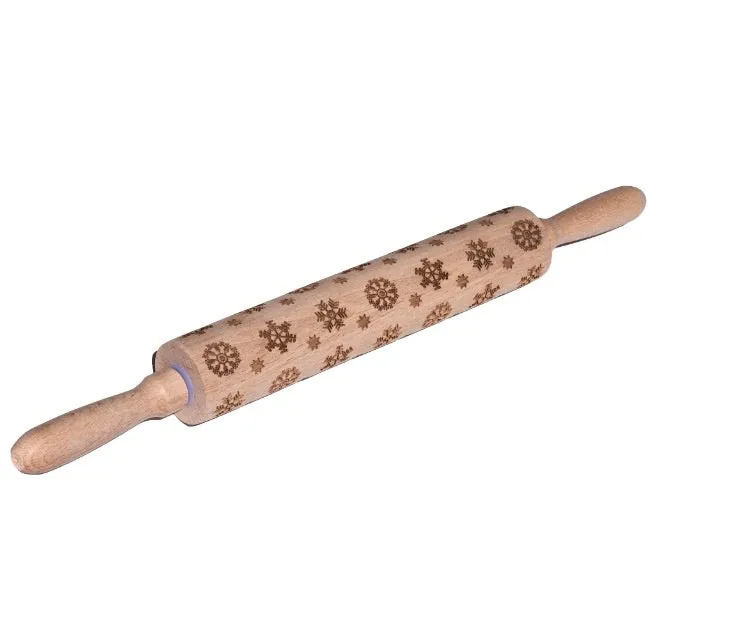 Wooden rolling pin with embossed Christmas patterns, 45cm long, on a kitchen worktop.