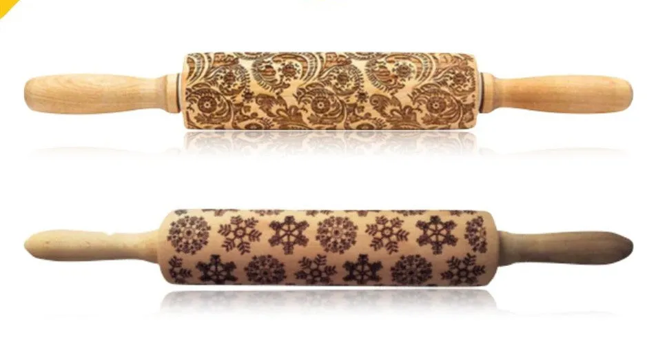 Wooden rolling pin with embossed Christmas patterns, 45cm long, on a kitchen worktop.