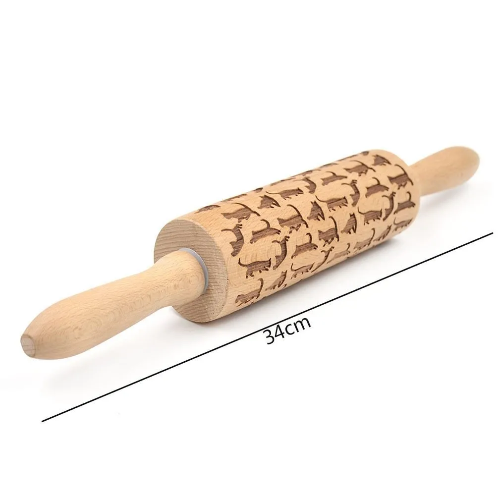 Wooden rolling pin with embossed Christmas patterns, 45cm long, on a kitchen worktop.