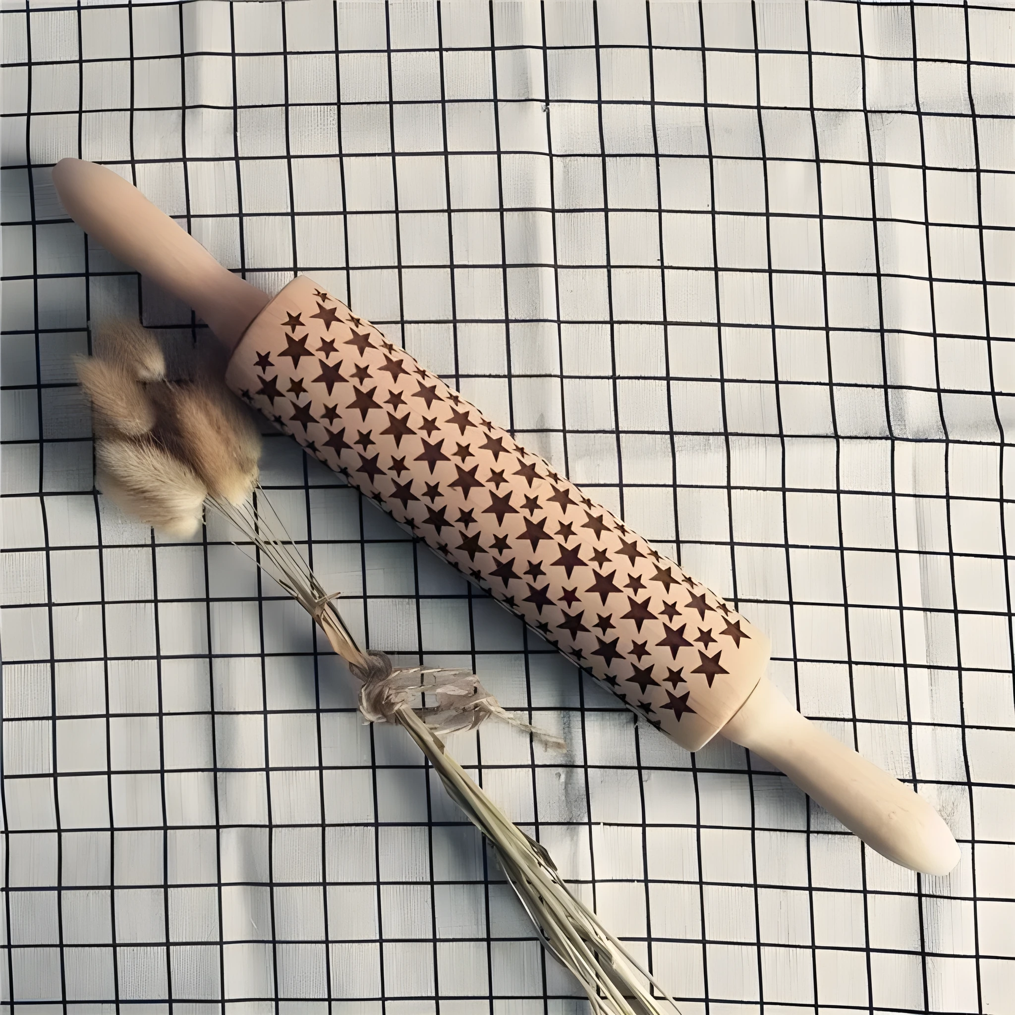 Wooden rolling pin with embossed Christmas patterns, 45cm long, on a kitchen worktop.