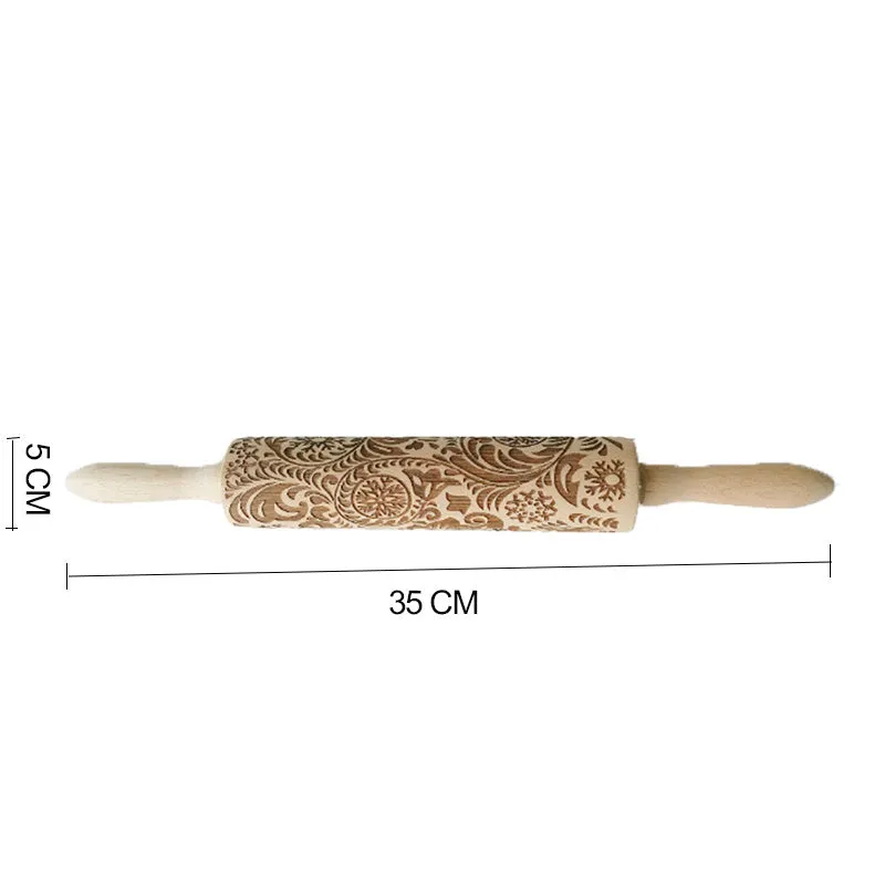 Wooden rolling pin with embossed Christmas patterns, 45cm long, on a kitchen worktop.