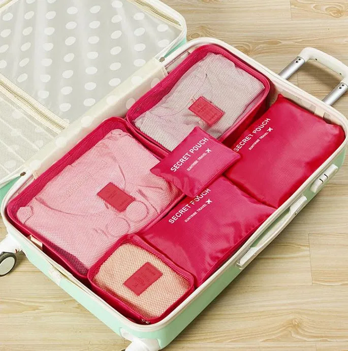 Set of six waterproof nylon packing cubes and organisers in assorted colours and sizes.