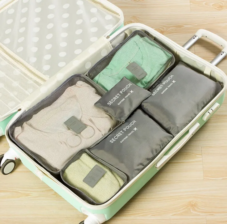 Set of six waterproof nylon packing cubes and organisers in assorted colours and sizes.