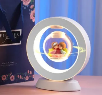 Pink floating heart LED levitation lamp with eternal flower on triangular base.