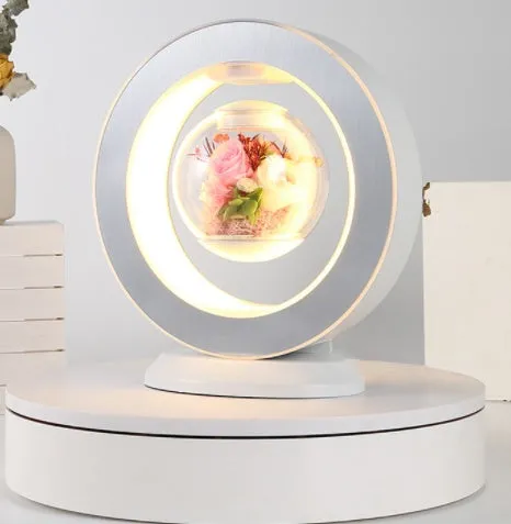 Pink floating heart LED levitation lamp with eternal flower on triangular base.