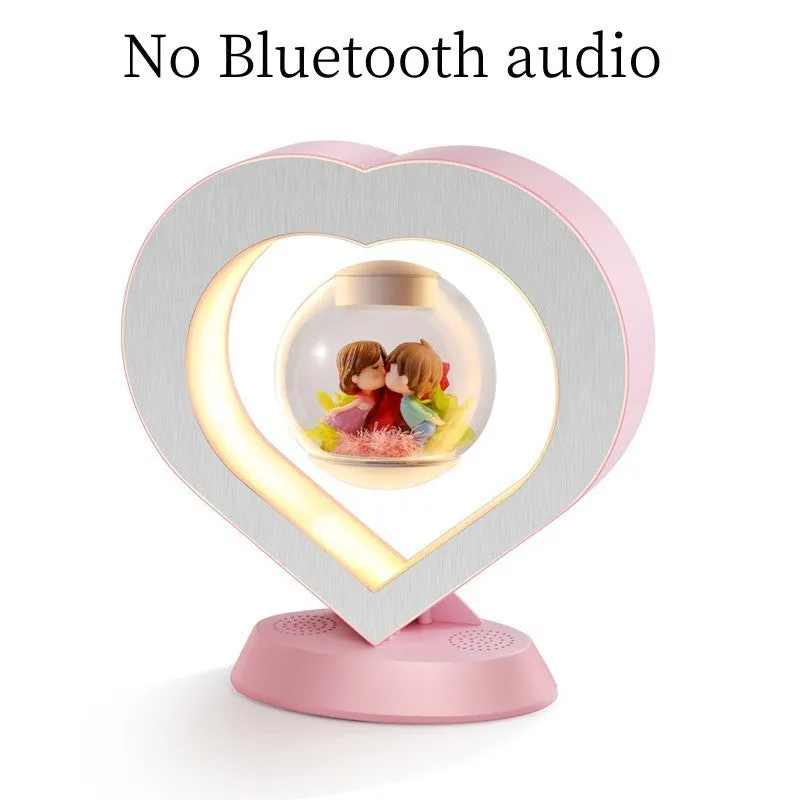 Pink floating heart LED levitation lamp with eternal flower on triangular base.