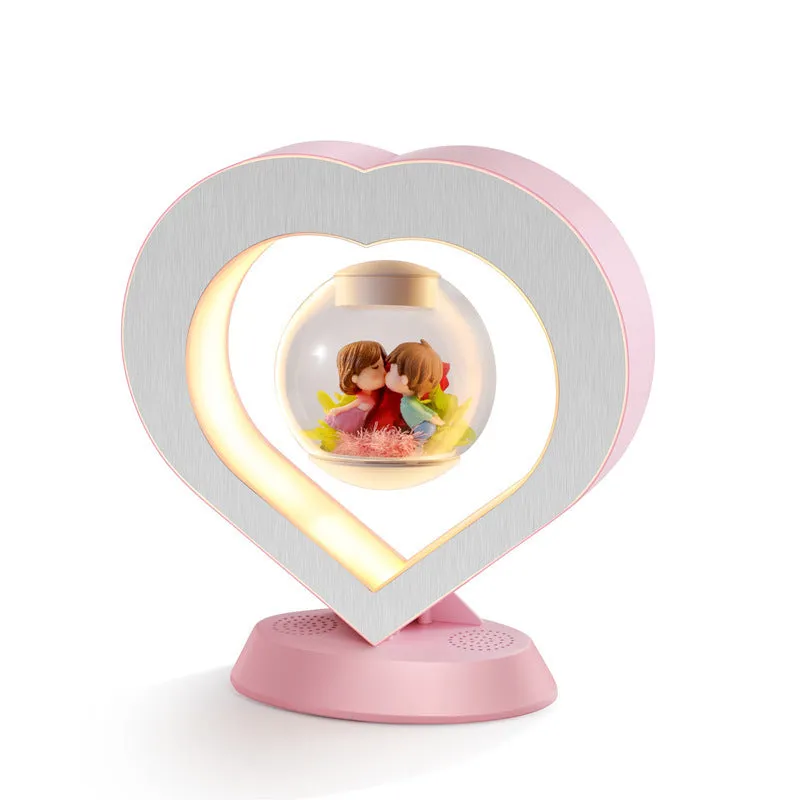 Pink floating heart LED levitation lamp with eternal flower on triangular base.