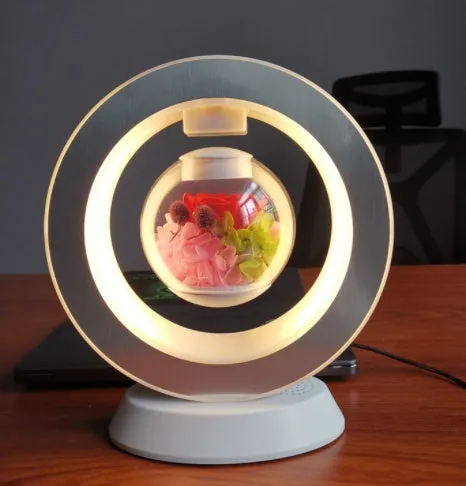 Pink floating heart LED levitation lamp with eternal flower on triangular base.