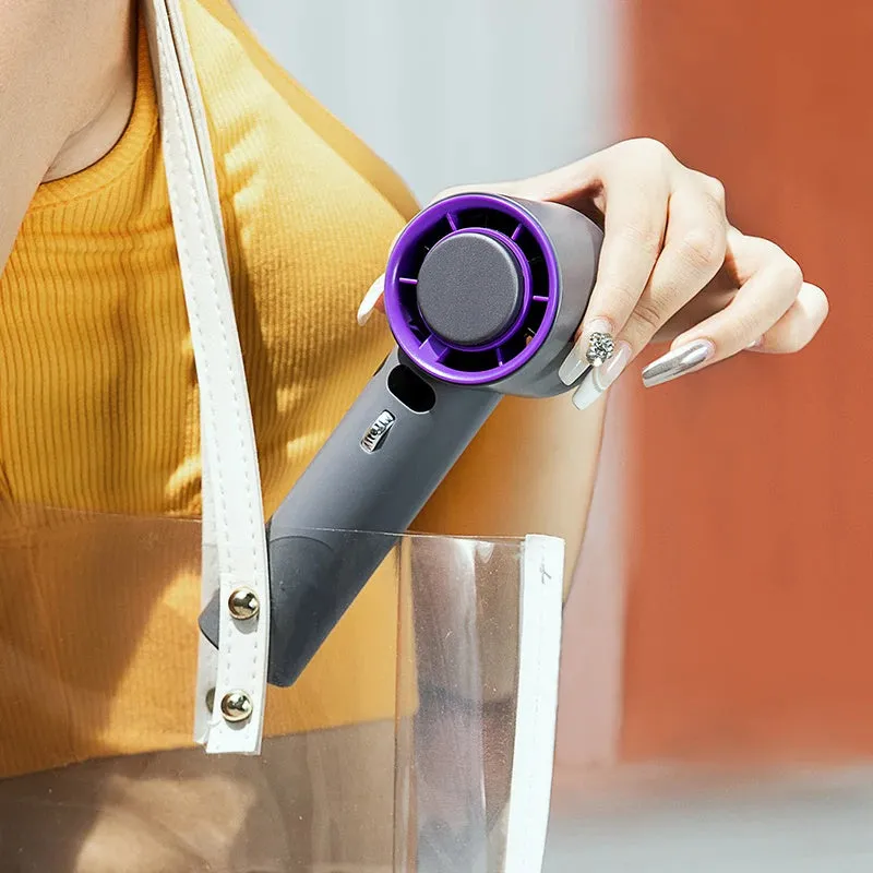 White portable handheld turbo fan with cooling function and display, shown on a table.