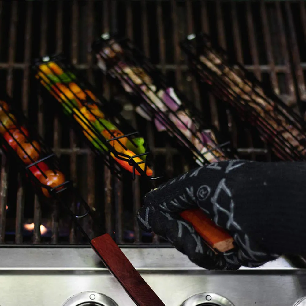 Burlywood coloured iron barbecue basket with a long wood handle for outdoor grilling.