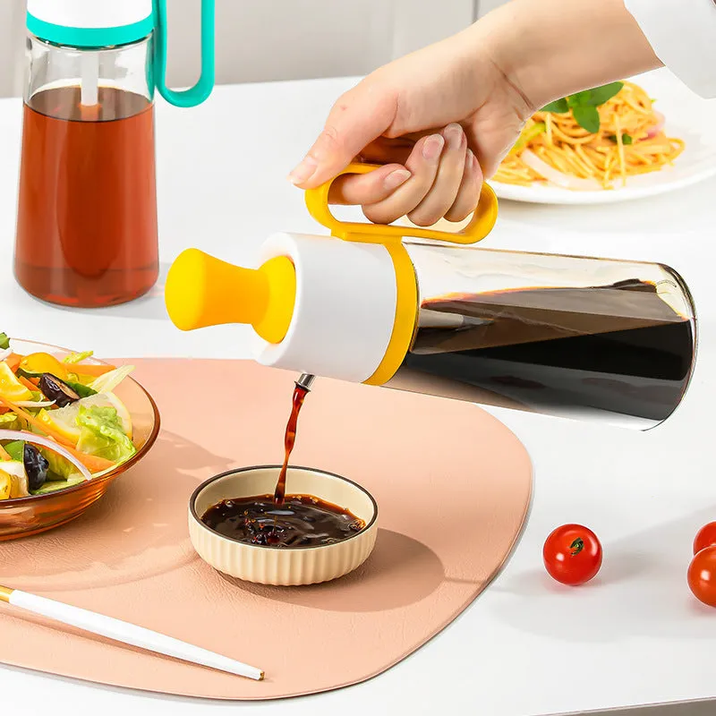 Transparent glass oil dispenser with silicone brush, stainless steel nozzle, in yellow, green, or brown.