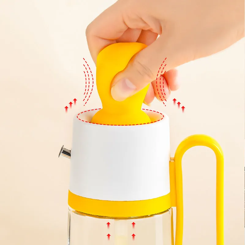 Transparent glass oil dispenser with silicone brush, stainless steel nozzle, in yellow, green, or brown.