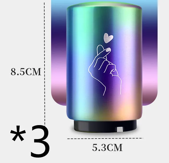 Stainless steel automatic bottle opener on a table, showing its compact size and press-down design.