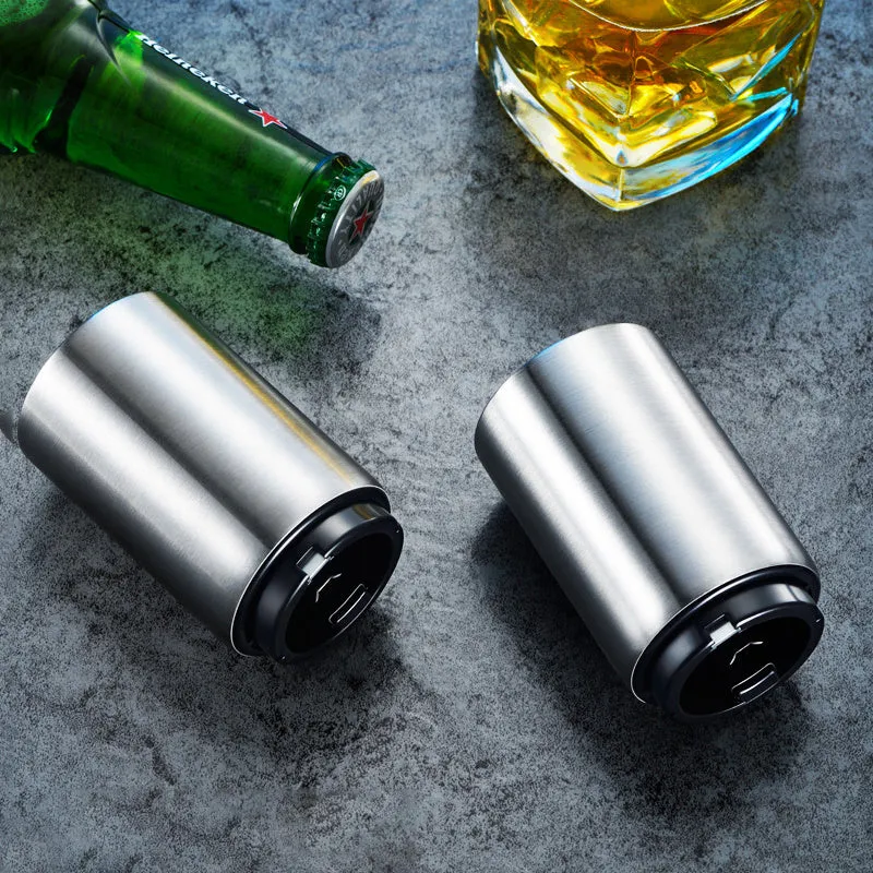 Stainless steel automatic bottle opener on a table, showing its compact size and press-down design.