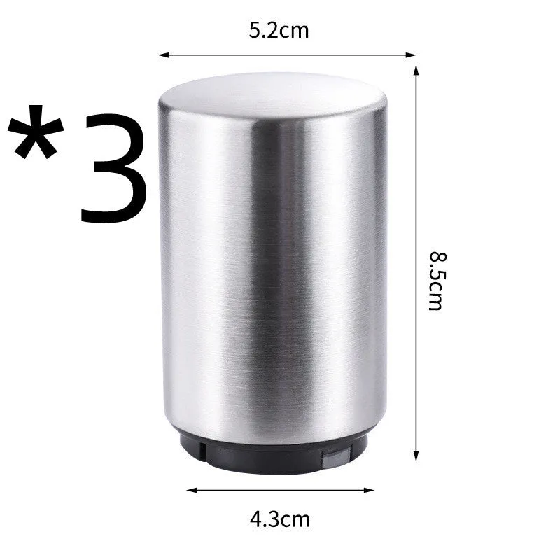 Stainless steel automatic bottle opener on a table, showing its compact size and press-down design.