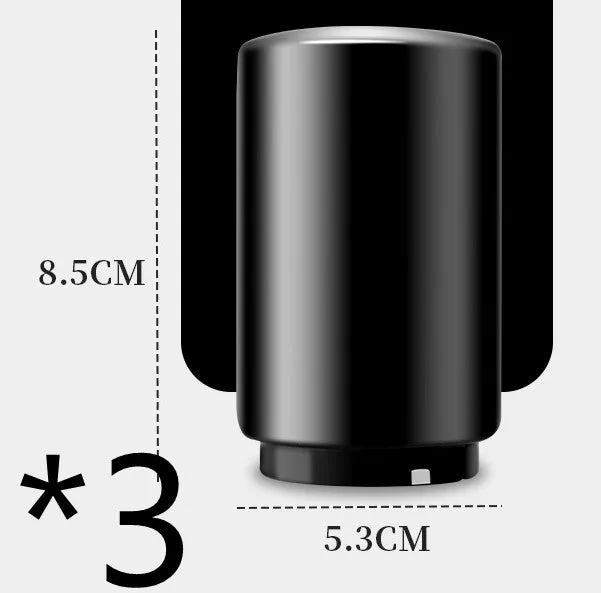 Stainless steel automatic bottle opener on a table, showing its compact size and press-down design.