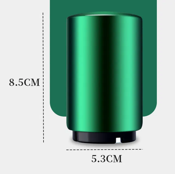 Stainless steel automatic bottle opener on a table, showing its compact size and press-down design.