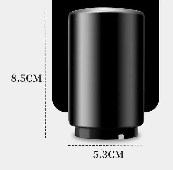 Stainless steel automatic bottle opener on a table, showing its compact size and press-down design.