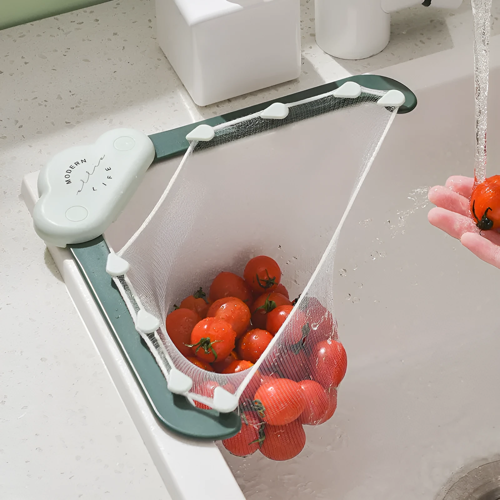 Grey triangular sink drain rack with a disposable filter mesh bag installed in a kitchen sink.