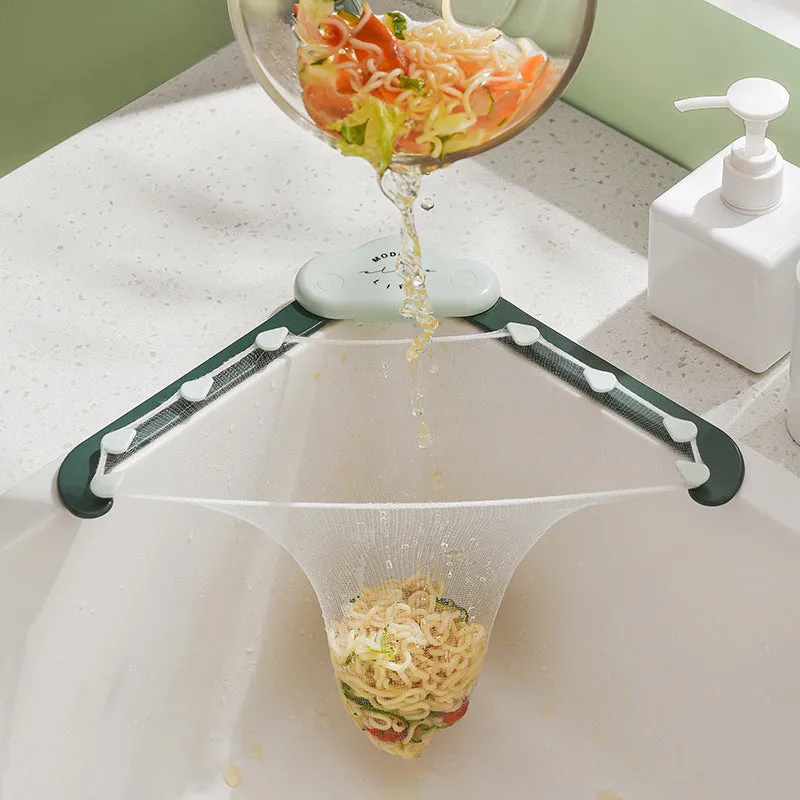 Grey triangular sink drain rack with a disposable filter mesh bag installed in a kitchen sink.