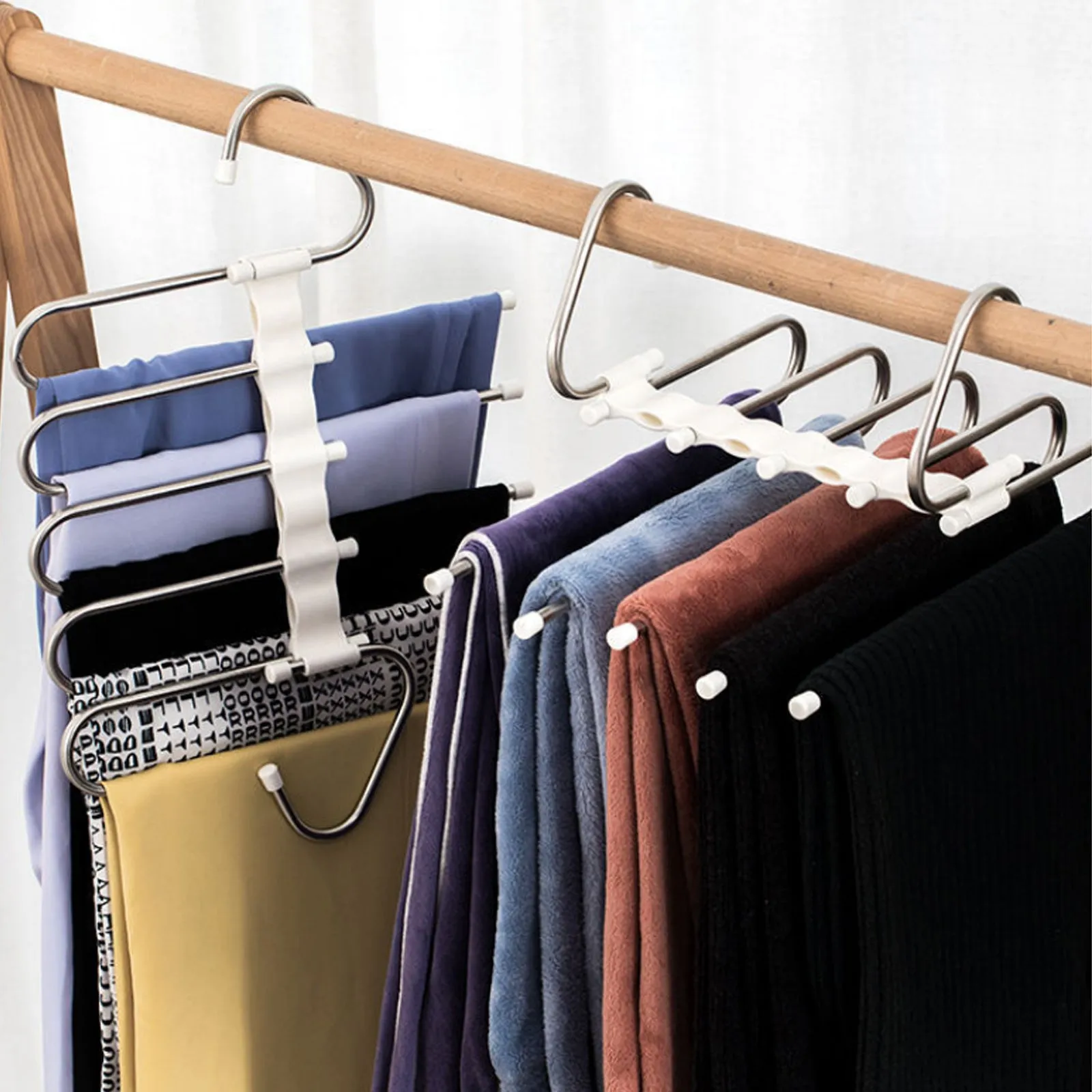 Black stainless steel magic wardrobe hanger with five booms for trousers.