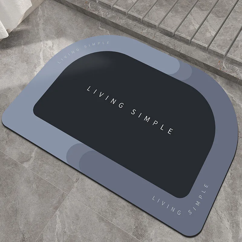 Oval grey polyester door mat with textured rubber non-slip backing on a wooden floor.
