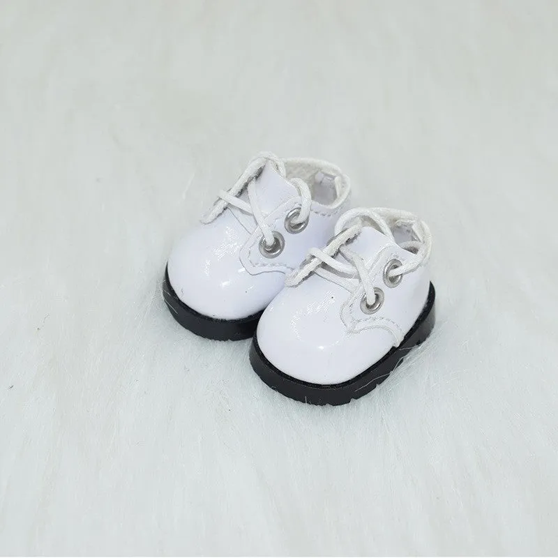 A pair of miniature PU replacement shoes for a 17cm fashion doll, shown in a selected style such as black boots.