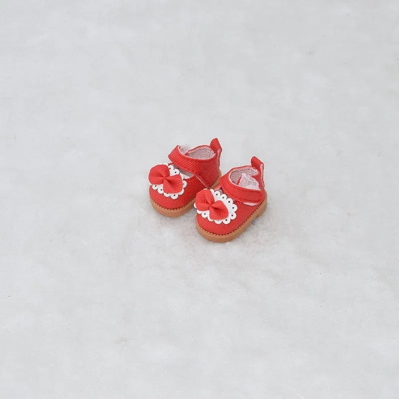 A pair of miniature PU replacement shoes for a 17cm fashion doll, shown in a selected style such as black boots.