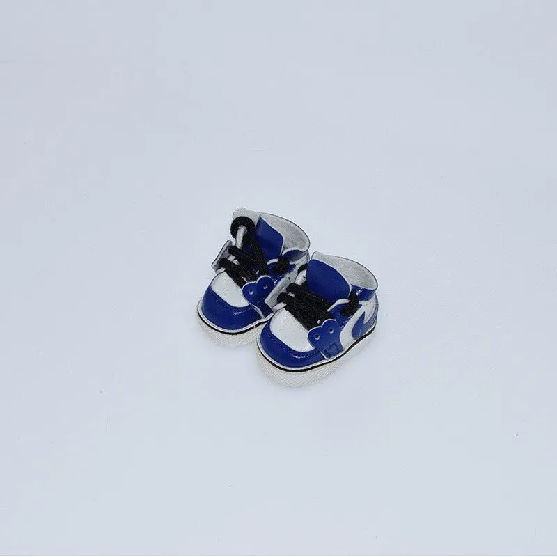 A pair of miniature PU replacement shoes for a 17cm fashion doll, shown in a selected style such as black boots.