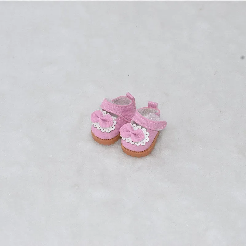 A pair of miniature PU replacement shoes for a 17cm fashion doll, shown in a selected style such as black boots.