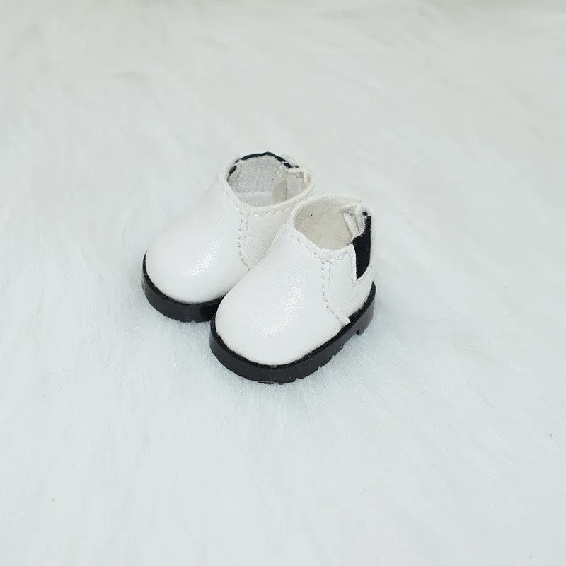 A pair of miniature PU replacement shoes for a 17cm fashion doll, shown in a selected style such as black boots.