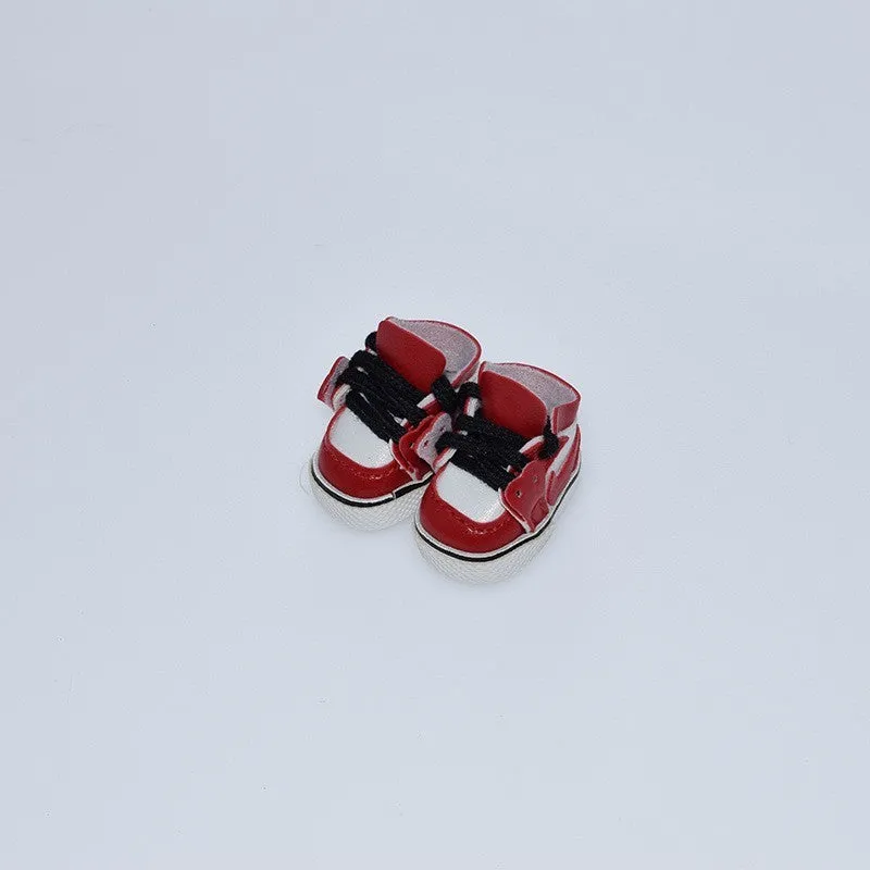 A pair of miniature PU replacement shoes for a 17cm fashion doll, shown in a selected style such as black boots.