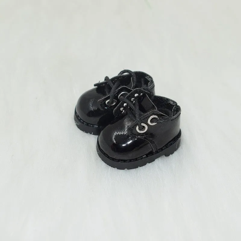 A pair of miniature PU replacement shoes for a 17cm fashion doll, shown in a selected style such as black boots.