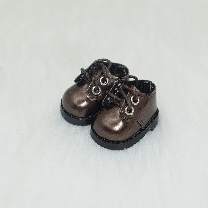 A pair of miniature PU replacement shoes for a 17cm fashion doll, shown in a selected style such as black boots.