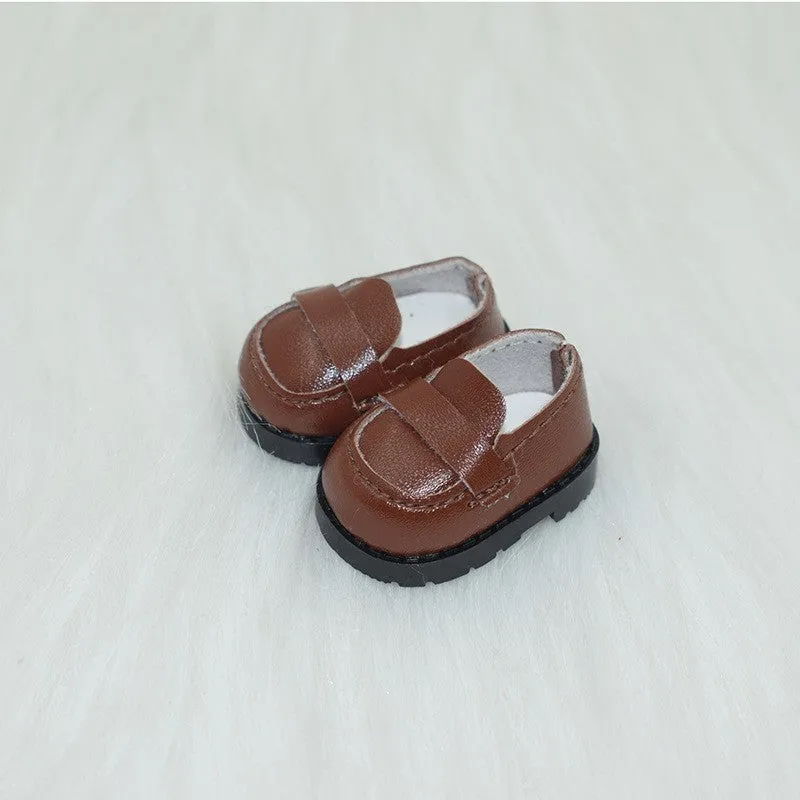 A pair of miniature PU replacement shoes for a 17cm fashion doll, shown in a selected style such as black boots.