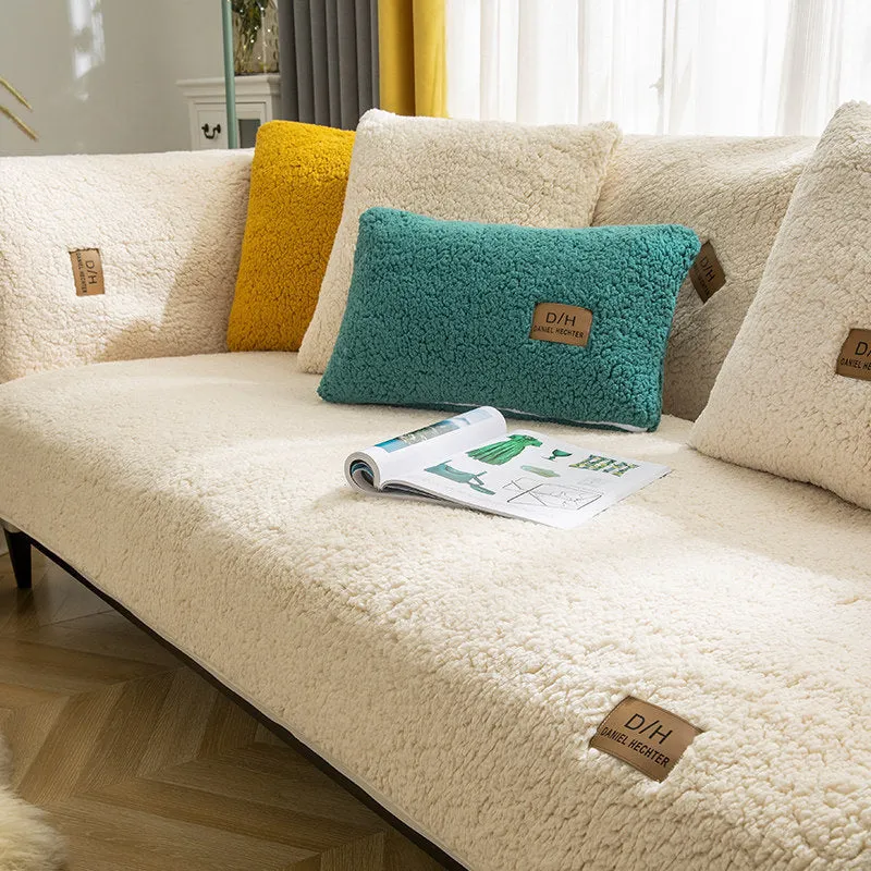 Beige plush sofa cover with anti-slip backing draped over a living room sofa cushion.