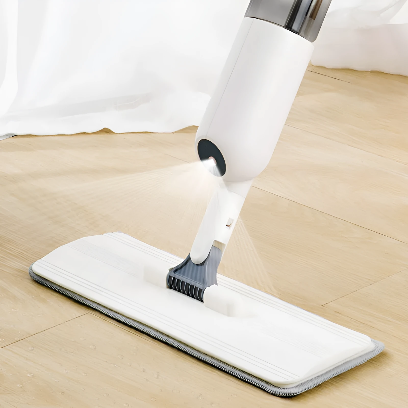 Flat cleaning mop with blue microfiber pad next to a white wringing bucket.