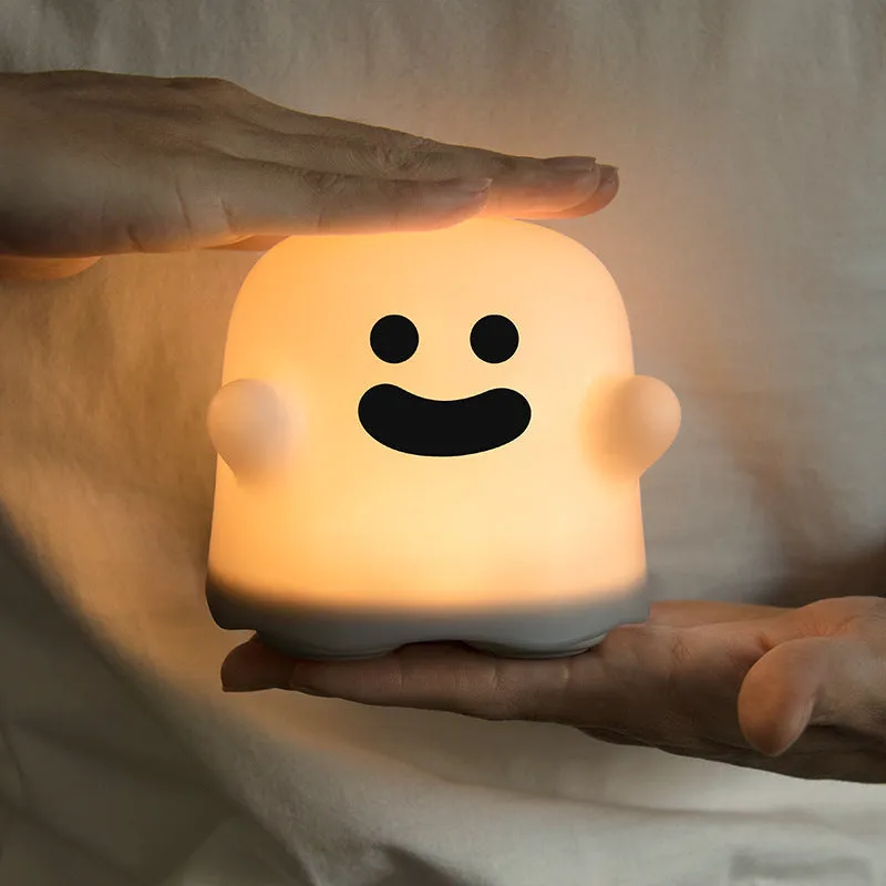 Silicone touch sensor LED night light on a bedside table showing soft glow.