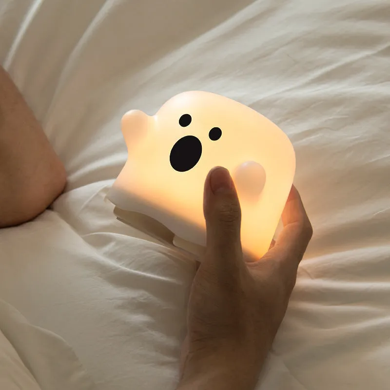 Silicone touch sensor LED night light on a bedside table showing soft glow.