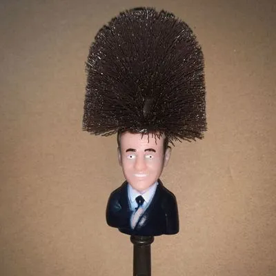 Yellow plastic Donald Trump toilet brush with 40cm length and hanging slot handle