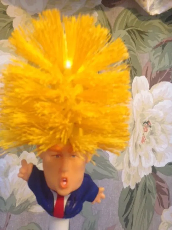 Yellow plastic Donald Trump toilet brush with 40cm length and hanging slot handle
