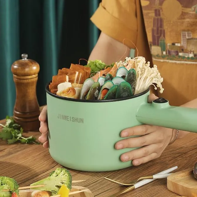 Compact white electric multi-function hot pot with non-stick interior on a kitchen countertop