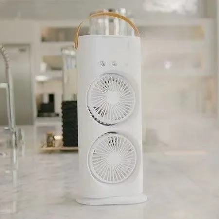 White double-ended portable USB fan with humidifying spray tank and remote control on a desk.
