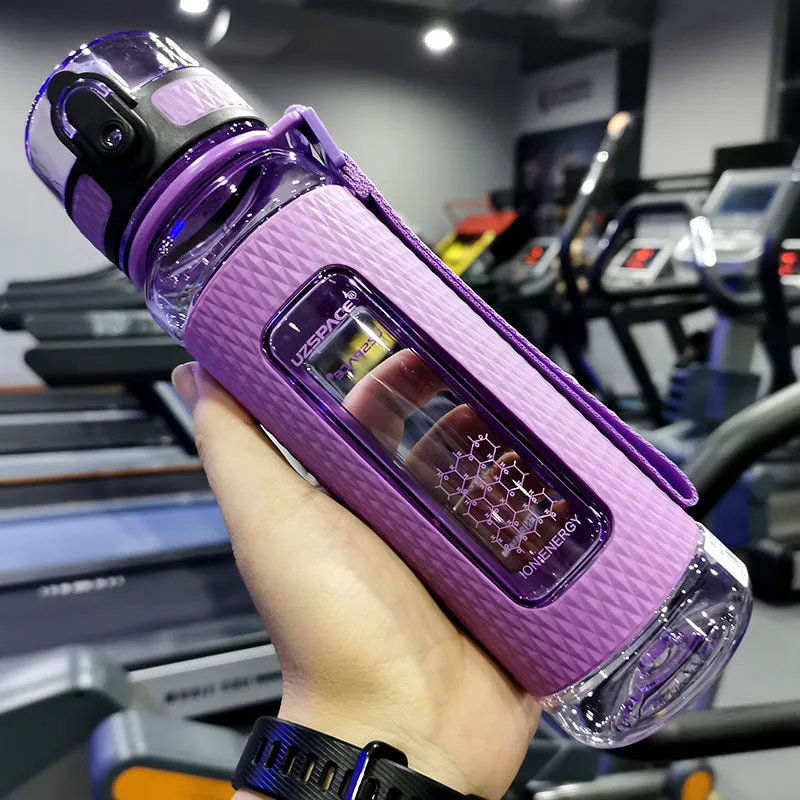 Blue portable sport water bottle with black lid on a gym bag.