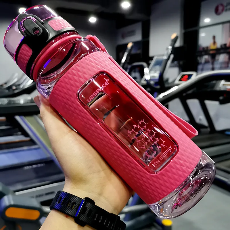 Blue portable sport water bottle with black lid on a gym bag.