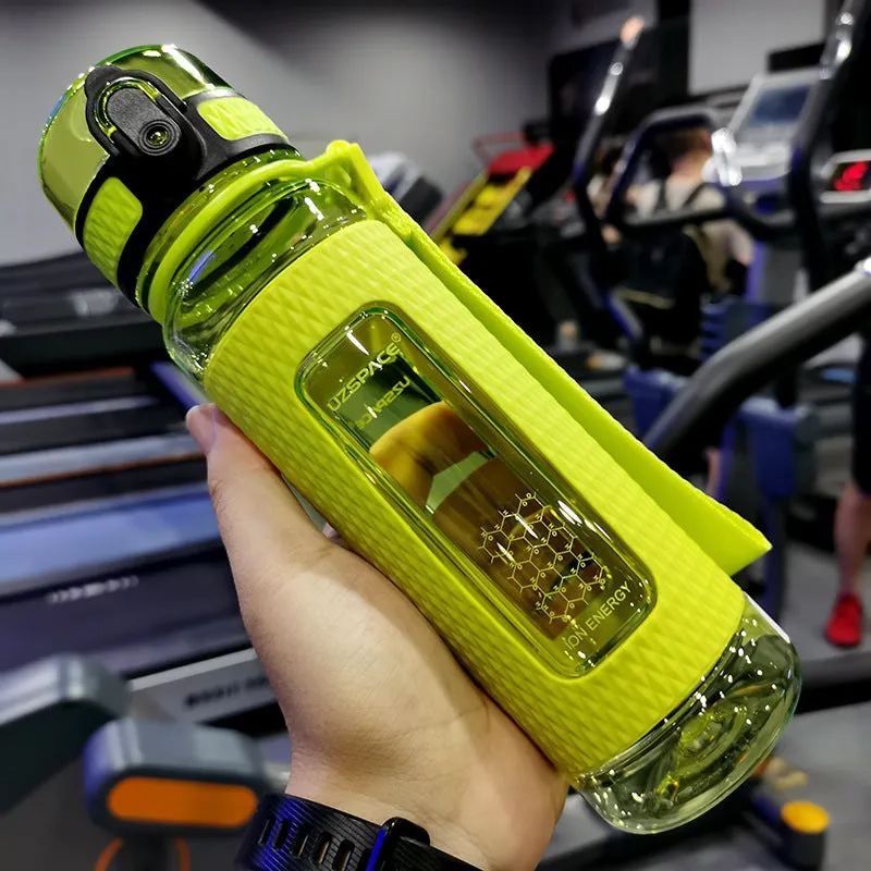 Blue portable sport water bottle with black lid on a gym bag.