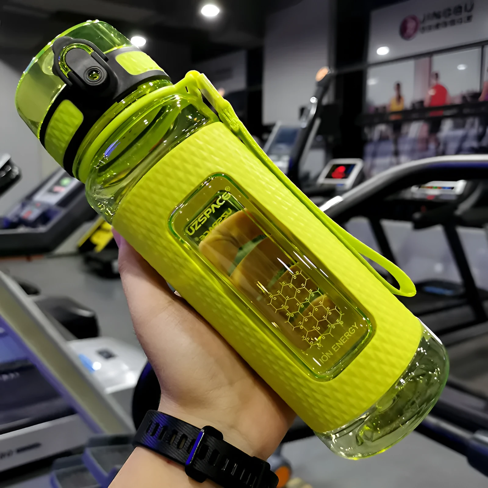Blue portable sport water bottle with black lid on a gym bag.
