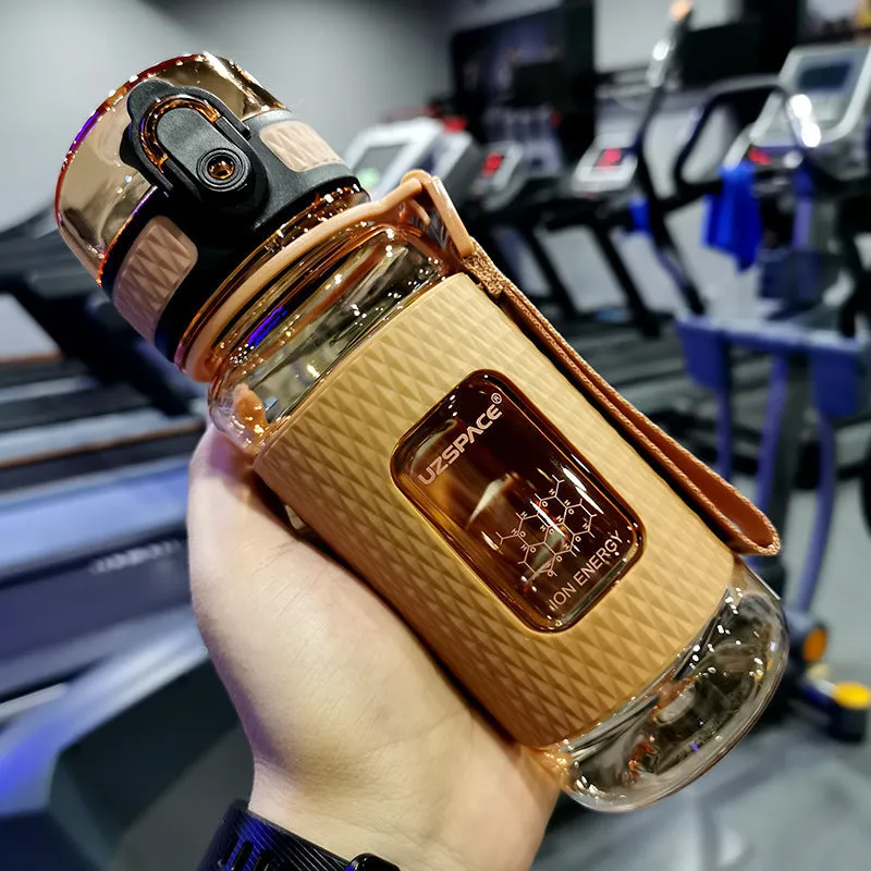 Blue portable sport water bottle with black lid on a gym bag.